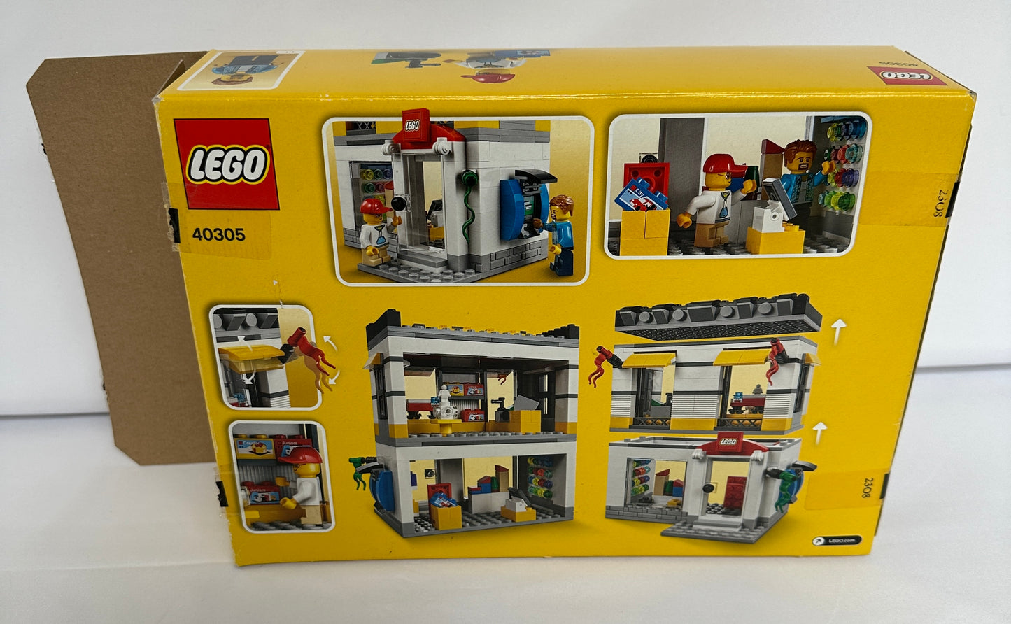 Yellow LEGO set box with multiple window panels showing the assembled model on a white background