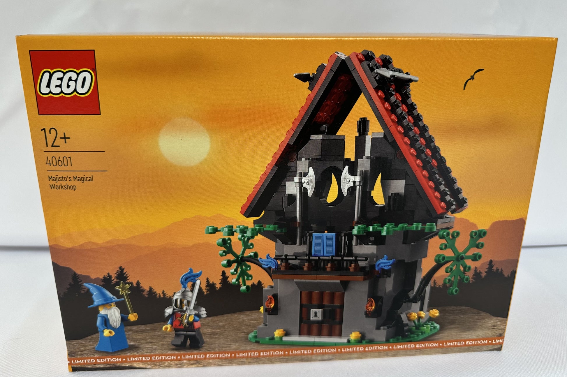 LEGO set packaging with a wizard's house and characters on an orange background