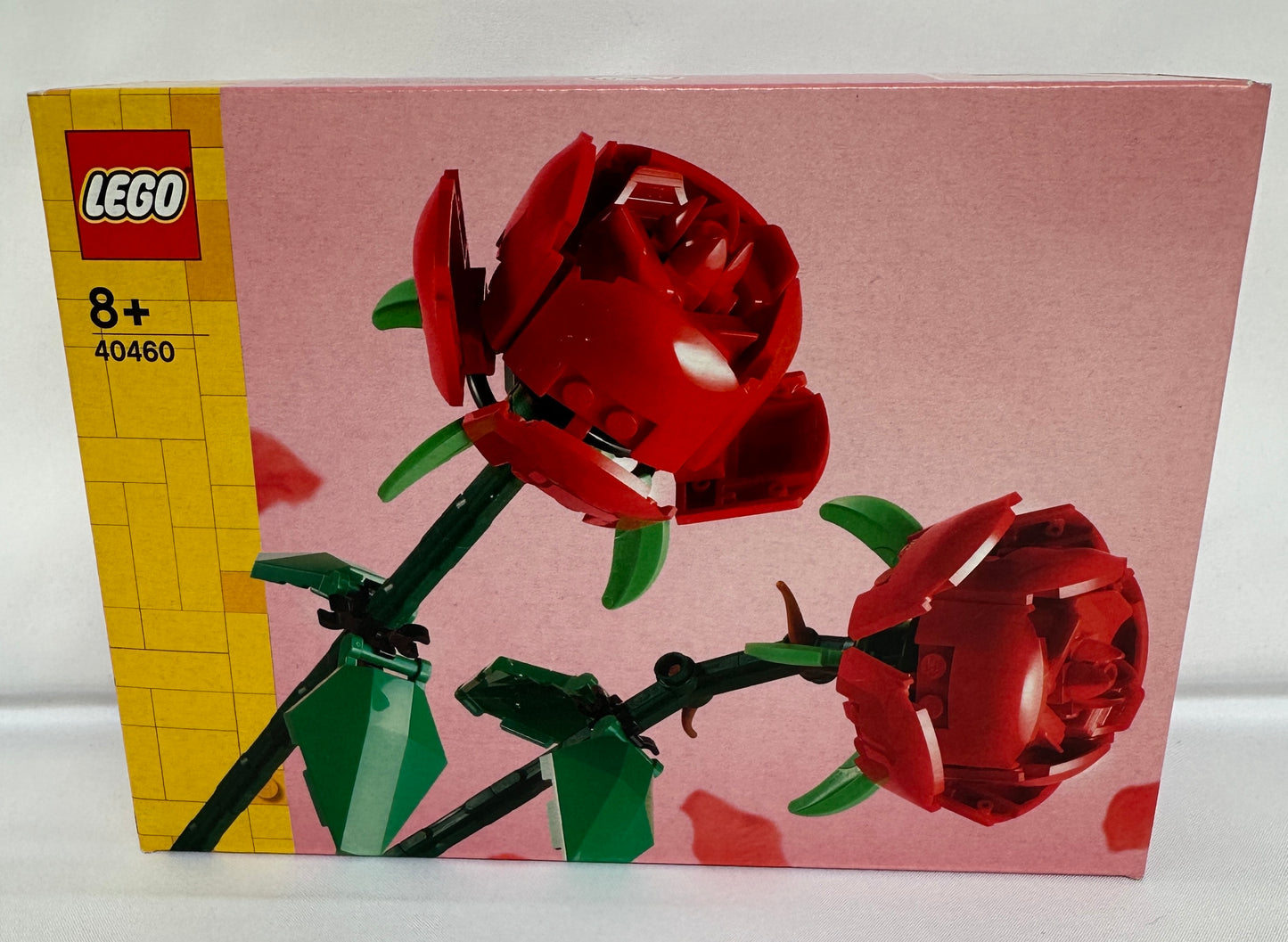LEGO set packaging with red floral design on a pink background