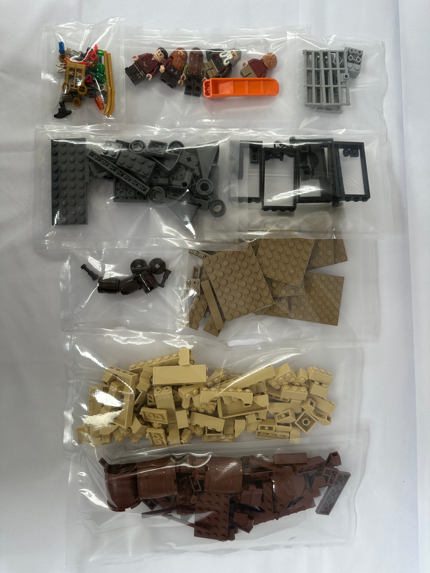 Assorted building blocks in clear plastic bags on a white background