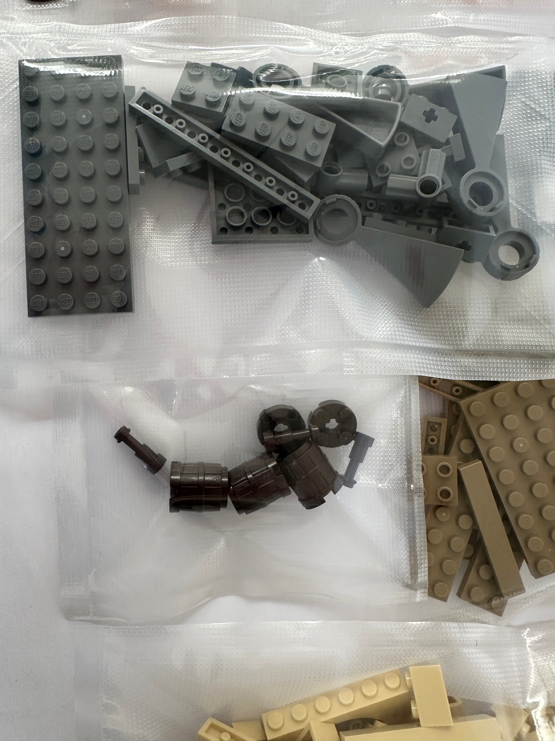 Assorted building blocks including bricks and figures on a white background