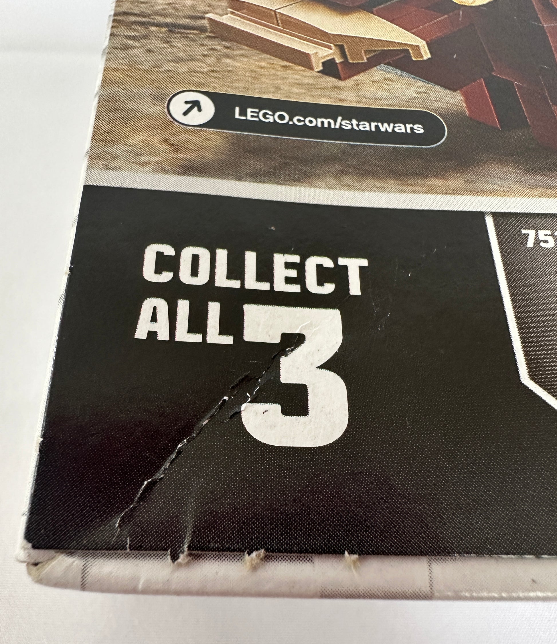 Close-up of a LEGO Star Wars packaging with 'Collect All 3' text and a website URL.