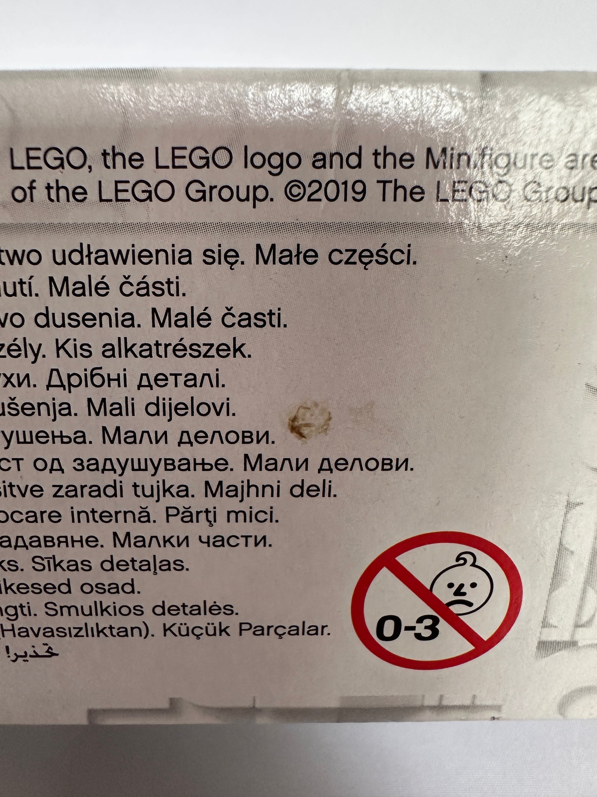 Warning label on a toy packaging with a no-entry symbol and text, featuring the LEGO logo.