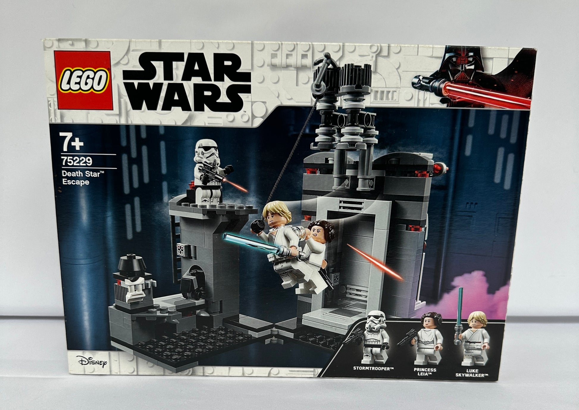 LEGO Star Wars packaging with characters and structures on a gray background