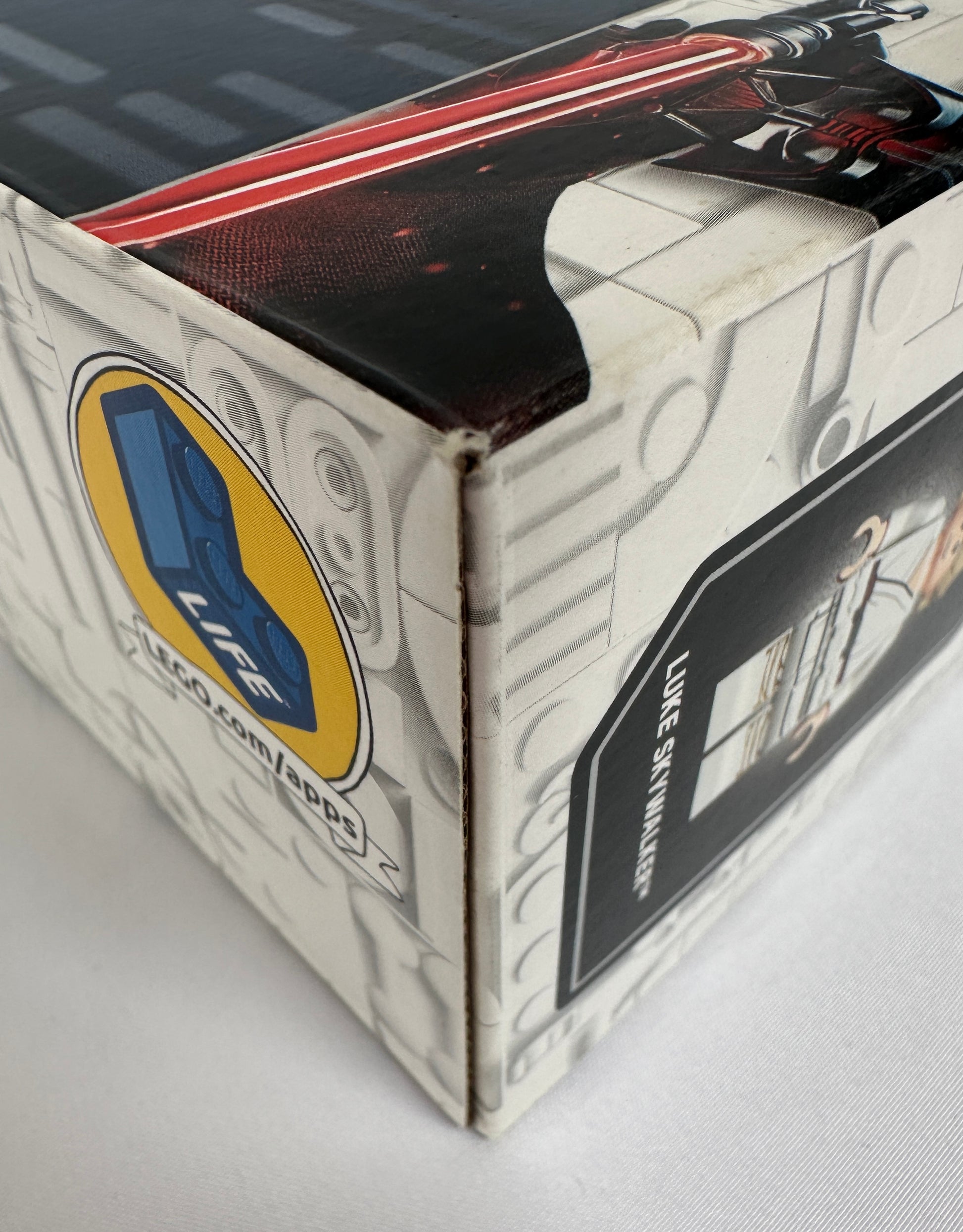 Box with a character design and visible branding on a gray background