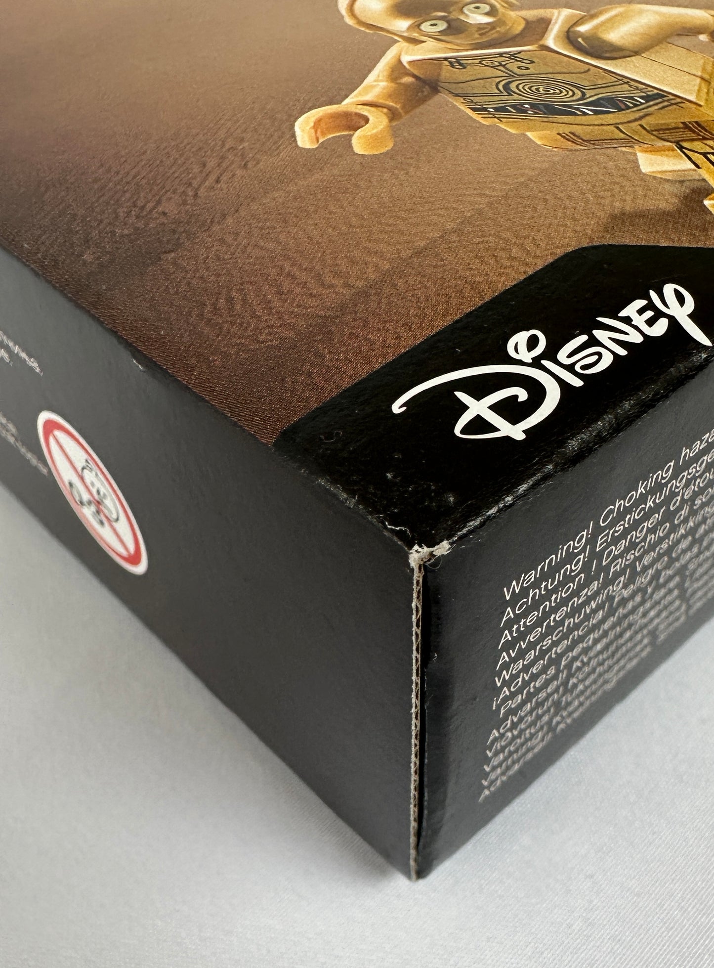 Close-up of a Disney product packaging with a character on a brown background.