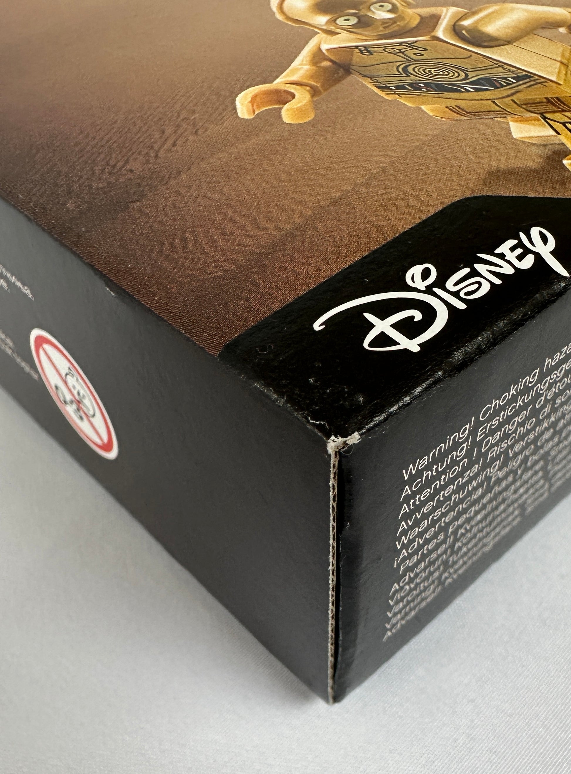 Close-up of a Disney product packaging with a character on a brown background.