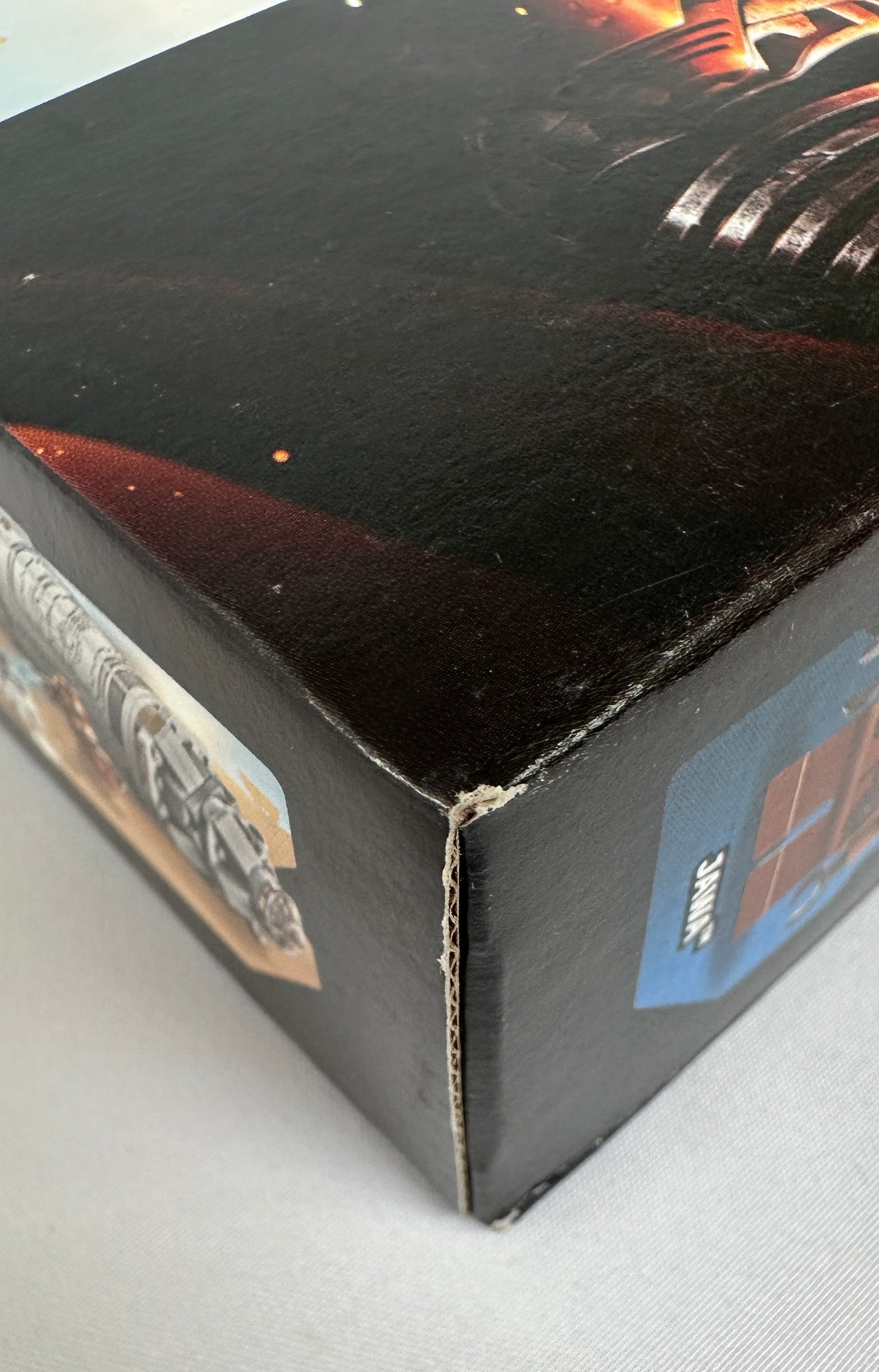 Close-up of a black box with text and graphics on a gray surface