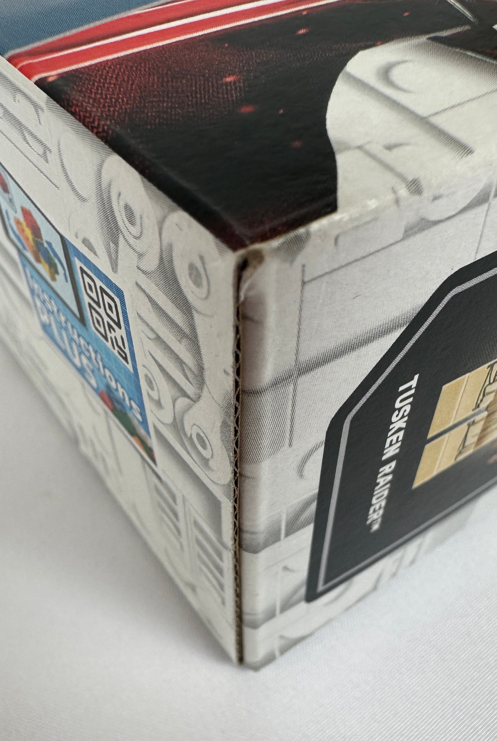 Close-up of a Star Wars toy packaging with a Tusken Raider figure on a white background