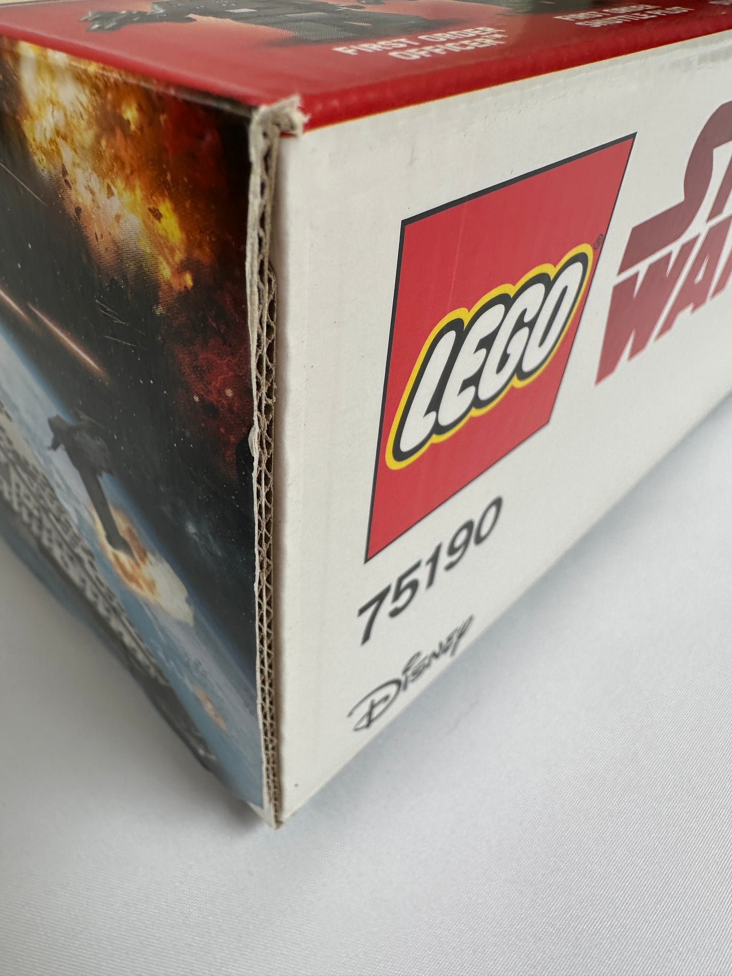 Close-up of a LEGO box with a visible brand logo on a white background