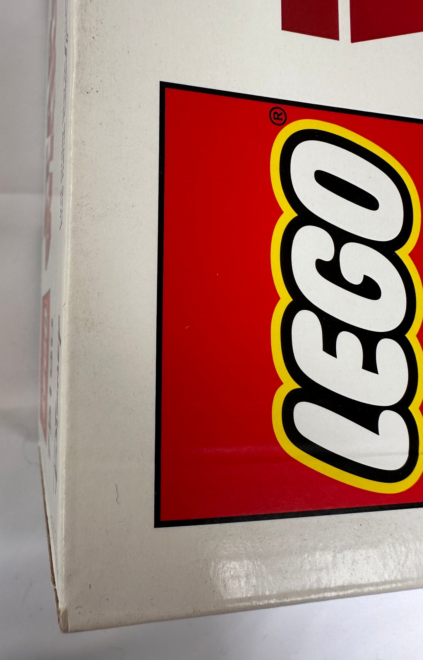 Close-up of a LEGO logo on a box corner.