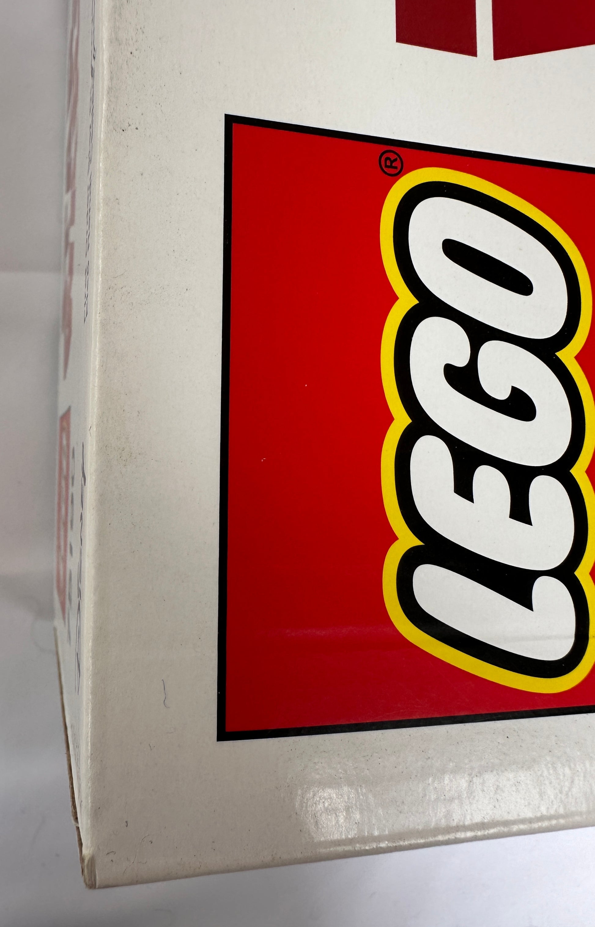 Close-up of a LEGO logo on a box corner.
