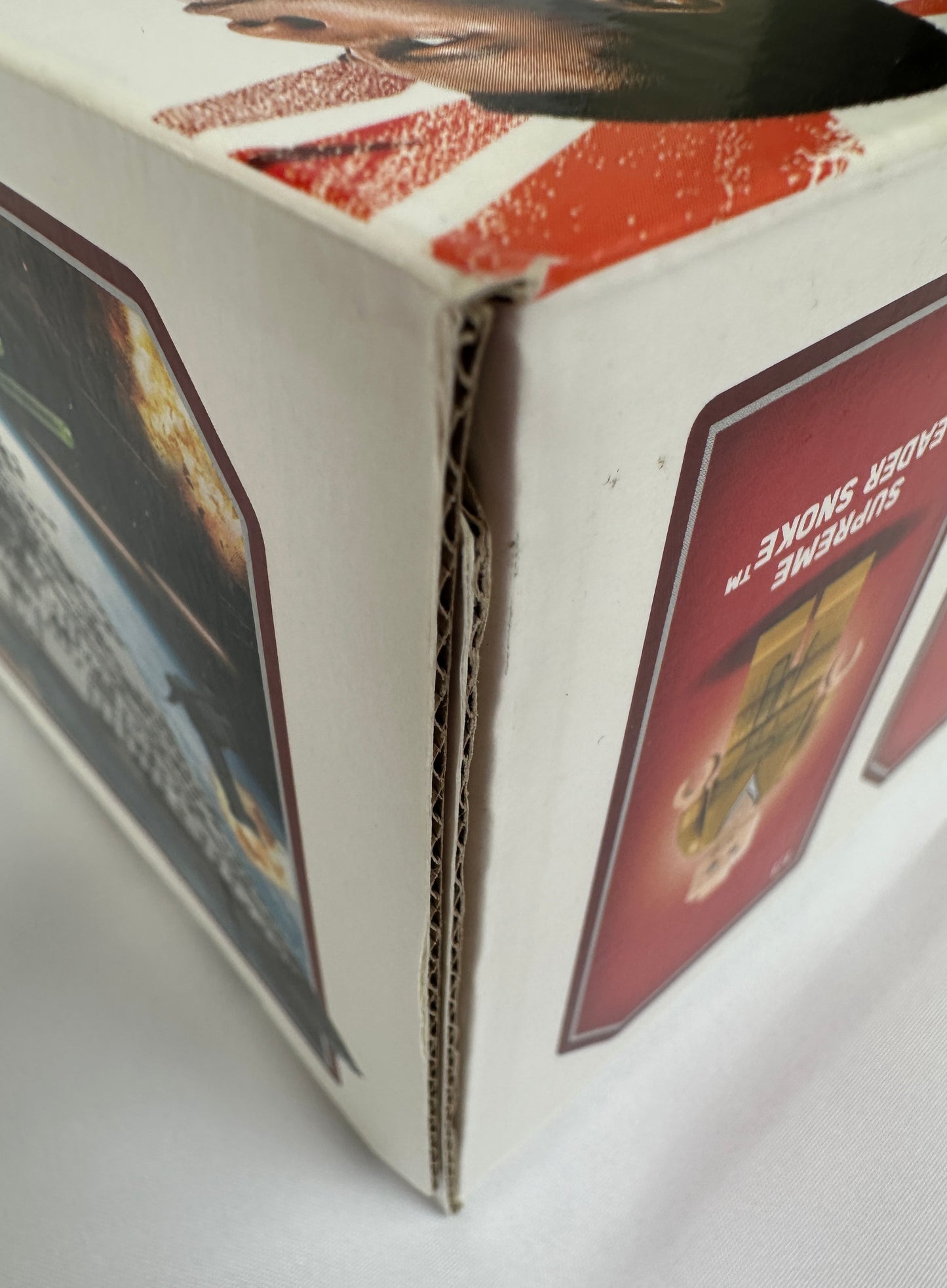 Close-up of a cardboard box with printed images on a white background