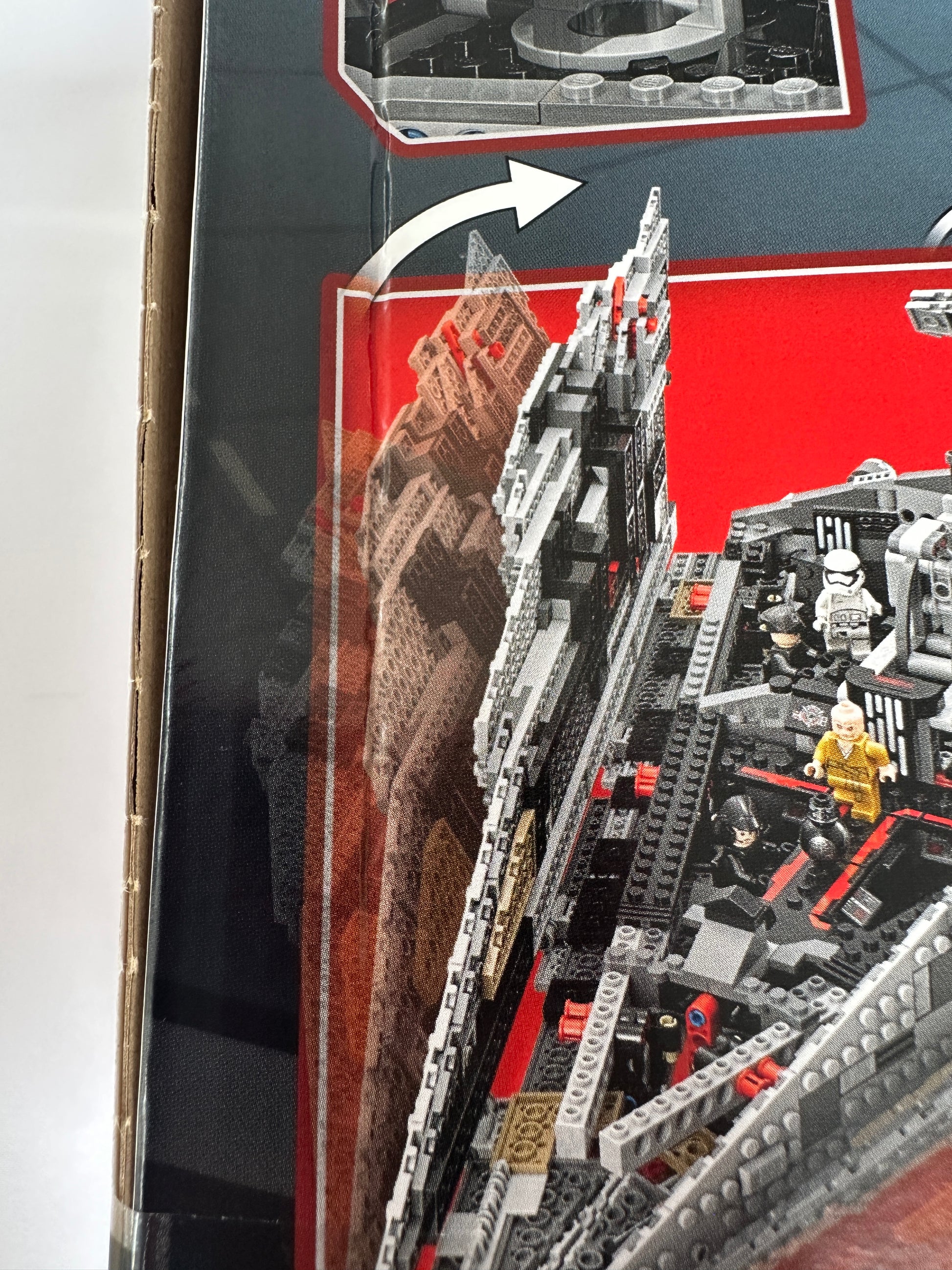 Close-up of a detailed model of a spaceship with a red interior, showing assembly instructions.