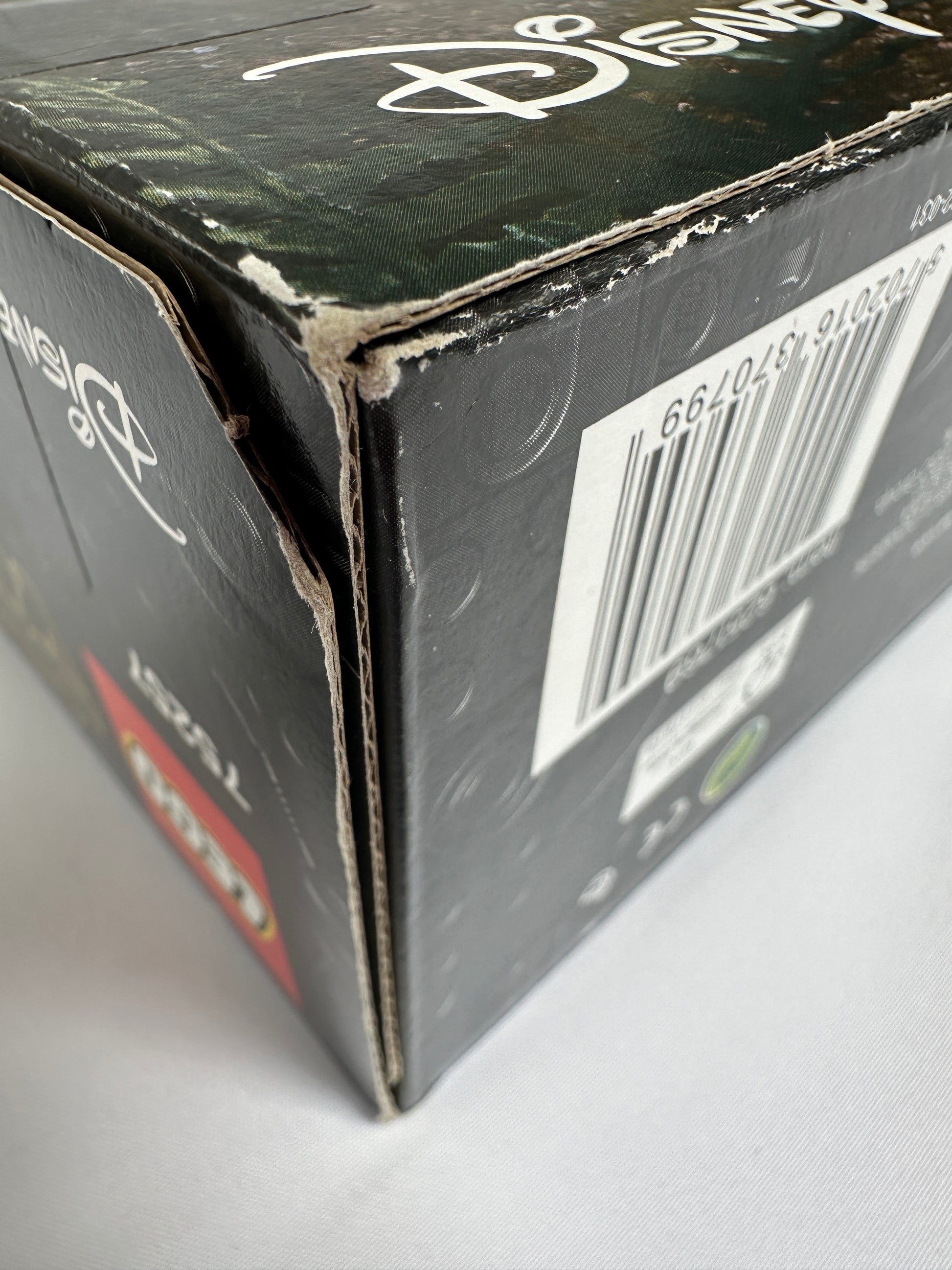 Close-up of a black box with a brand logo and bar code on a white background